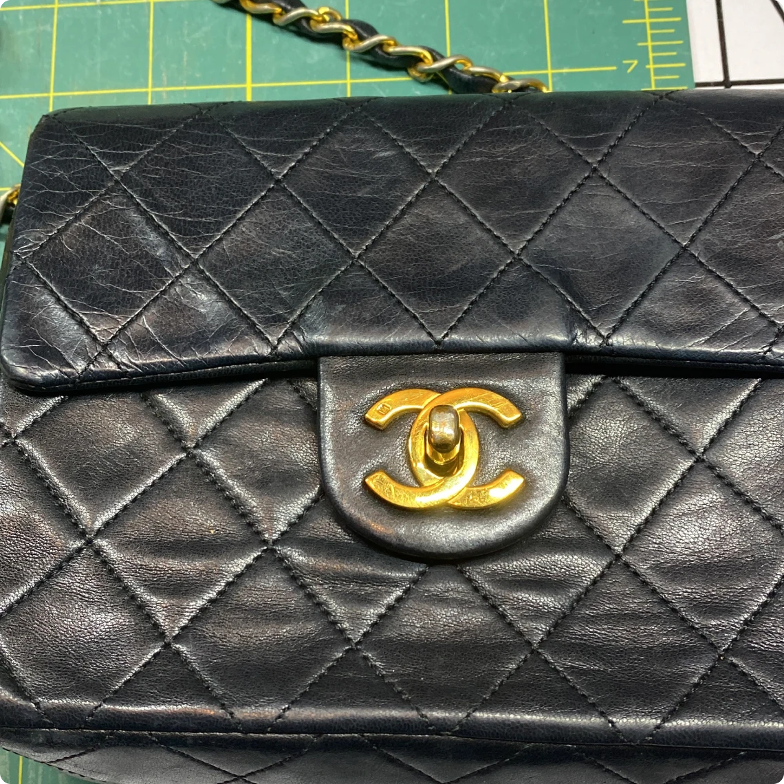 Elegant leather purse on green background